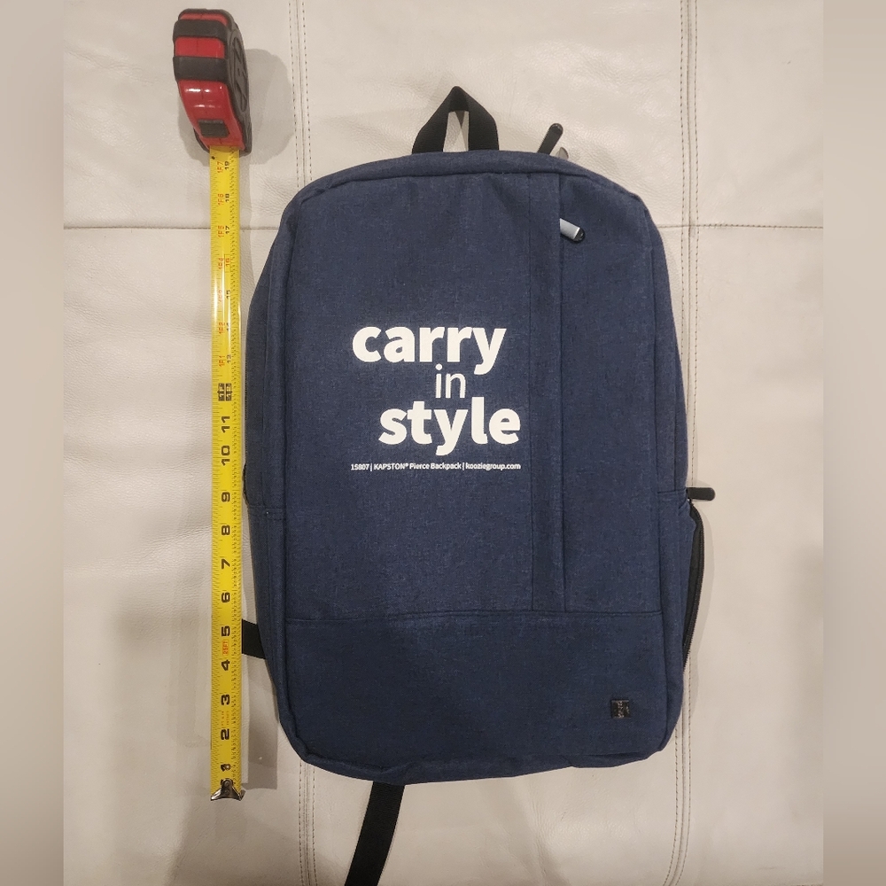Navy blue canvas backpack with white stitching, featuring a spacious main compar
